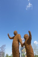 Two giant figures covered with 10,000 bees made of Corten steel designed by Florentijn Hofman named Beehold.