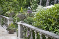 Balustrade with planted urns on the terrace at Hamilton House garden in May 
