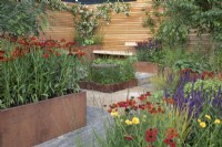 Corten steel planters full of colourful perennials in the Lunch Break Garden at RHS Hampton Court Palace Garden Festival 2022