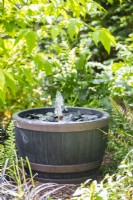 Simple slate water fountain in a shaded border