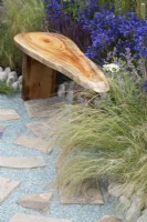 Stipa tenuissima - Mexican feather grass and Recycled glass stone pathway on the Journey Home garden RHS Tatton Park Flower Show 2022 - Designed by Rachael Bennion and Petrus Community