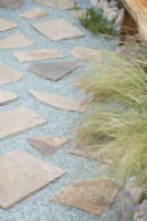 Stipa tenuissima - Mexican feather grass and Recycled glass stone pathway on the Journey Home garden RHS Tatton Park Flower Show 2022 - Designed by Rachael Bennion and Petrus Community