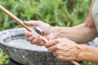 Woman cutting copper pipe