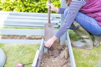 Woman positioning small post for inside corner