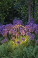 Spherical garden light amongst Alliums