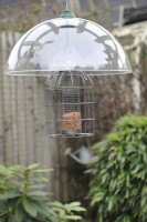 Squirrel proof bird feeder with plastic baffle