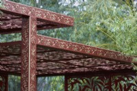 Morris  and  Co. Garden. Designer: Ruth Willmott. RHS Chelsea Flower Show 2022. Gold Medal. Detail of pavilion crafted from laser cut metal with 'Willow Boughs' William Morris design. 