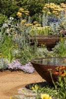 Rust-coloured reflective water bowls with drought-resistant planting - RHS Hampton Court Palace Garden Festival, London July 2022 - RHS Planet-friendly Garden; RHS Feature Garden - Designer Mark Gregory