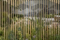 View through the screen in The Memories of Mountains Garden Retreat Garden at BBC Gardeners World Live 2022