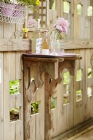 Painted tray shelf on trellis with vintage wood brackets