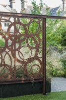 Bespoke corten steel screen in contemporary walled town garden. August