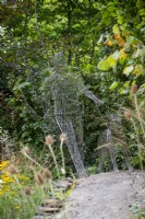 Wire man and dog sculpture by Tom Hill - Guide Dogs 90th Anniversary Garden, RHS Chelsea Flower Show 2021