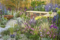 Low maintenance gravel garden with gabion bench, Corten steel water bowl and drought tolerant plants to attract pollinators, such as Salvia, Achillea, Echinops, Perovskia, Stachys byzantina, Eryngium, Santolina and Betula - Turfed Out, RHS Hampton Court Palace Garden Festival 2022