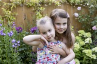 Two young girls playing in a garden