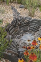 Decorative slate feature in gravel garden