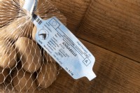 Dutch language EU plant passport label on a bag of seed potato's  'Annabelle' solanum tuberosum. Such certification is required for transportation in the EU of certain plants and seeds in order that the origins can be traced.