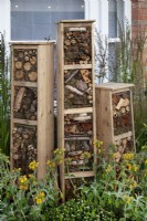 Tiered insect hotels made from recycled materials in the 'Living in Sync' garden at BBC Gardener's World Live 2017 - June