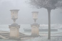 Neoclassical carved stone urns on a frosty morning in the Italian Garden at Chiswick House and Gardens