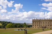 Statues, a fountain on the parterre and a view to the surrounding parkland next to Chatsworth House and Garden.