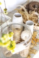 Glass jar with reels of twine