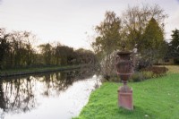 Terracotta urn beside the canal that borders John Massey's garden in October.