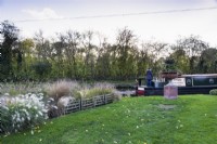 Narrowboat passing John Massey's garden in October.