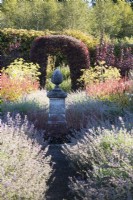 Pine cone finial surrounded by Nepeta 'Six Hills Giant' in September at Whitburgh House Walled Garden.