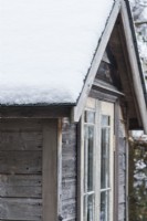 Detail of corner of small summerhouse made from a re-styled garden shed and salvaged materials. December.