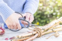 Woman cutting off excess rope