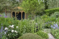 Borders with Miscanthus 'Morning Light', Cynara cardunculus, Thalictrum 'Black Stockings', Foeniculum vulgare and Baptisia australis - The RNLI Garden, RHS Chelsea Flower Show 2022
