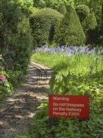 Miniature railway running through woodland garden