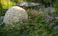 Horatio's Garden, a show garden designed by Charlotte Harris and Hugo Bugg featuring a stone cairn and water feature surrounded by herbaceous planting  and accessible areas for people affected by spinal injuries.  