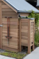 Cedar garden shed with a waterbutt attached to the roof gutter.

The Gabriel Ash showstand at RHS Chelsea Flower Show 2023.