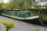 Canal Street garden with a real barge and canal lock. Trago Mills show gardens, Devon, UK. May. Spring