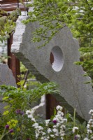 The Samaritans Listening Garden. Designer: Darren Hawkes. Chelsea Flower Show 2023. A garden of salvaged materials and suspended concrete panels. Summer. May.