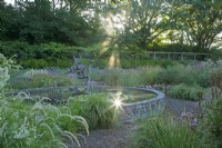 View of the circular Dragon Pond at Knoll Gardens, Dorset at sunrise