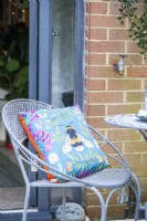 Metal garden chair with patterned cushion