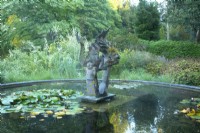 Sculpture in the centre of the circular Dragon Pond at Knoll Gardens, Dorset