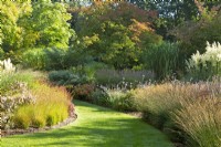 Mixed perennial borders line the lawned path of 'The Long Walk' at Knoll Gardens in Dorset