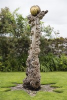 The Elm Monument in the South Garden. Gold painted wooden globe mounted on weathered trunk of elm tree. August.