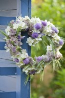 Heart shaped wreath containing mock orange, field scabious, astrantia and wheat.
