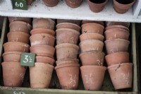 Drawer full of terracotta plant pots, sized.
