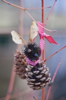 Hanging squirrel decoration made of cones, seeds and seedhead.