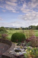 Water feature on a raised bed in a country garden in September