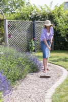 Woman sweeping path to level out the stones