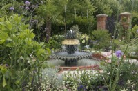 A formal garden based on the historic courtyard gardens of Charleston, South Carolina, with a pineapple water feature representing the famous Charleston waterfront fountain.  Explore Charleston - Welcome to Charleston, RHS Hampton Court Palace Garden Festival 2023.  