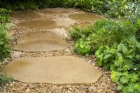 A natural paving and gravel path on The London Square Community Garden - Sanctuary Gardens - Designer James Smith - RHS Chelsea Flower Show 2023