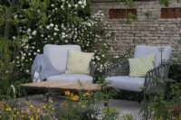 Wildlife friendly planting surrounds a secluded seating area on the RSPCA Garden designed by Martyn Wilson - RHS Chelsea Flower Show 2023