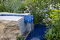 A rill made of recycled plastics surrounded by wildlife friendly planting on the RSPCA Garden designed by Martyn Wilson - RHS Chelsea Flower Show 2023