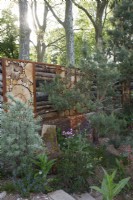 View of the boundary wall built with logs in The Royal Entomological Society Garden - Designer: Tom Massey -Sponsor: Project Giving Back -